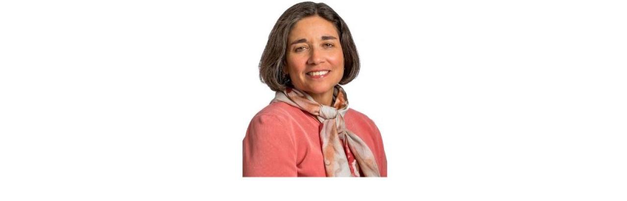 color photo of Linda Ehrlich-Jones, a middle aged white woman with shirt brown hair and a pink jacket