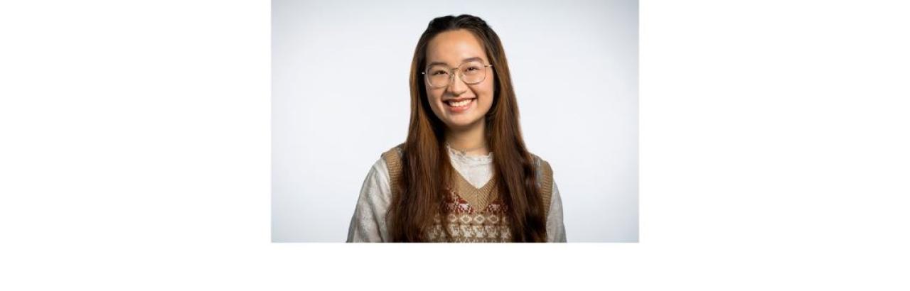a photo of My Le, a Vietnamese young woman with long brown hair and glasses