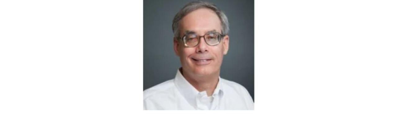 color photo of Mike Whelan, a middle aged white man with grey hair and glasses