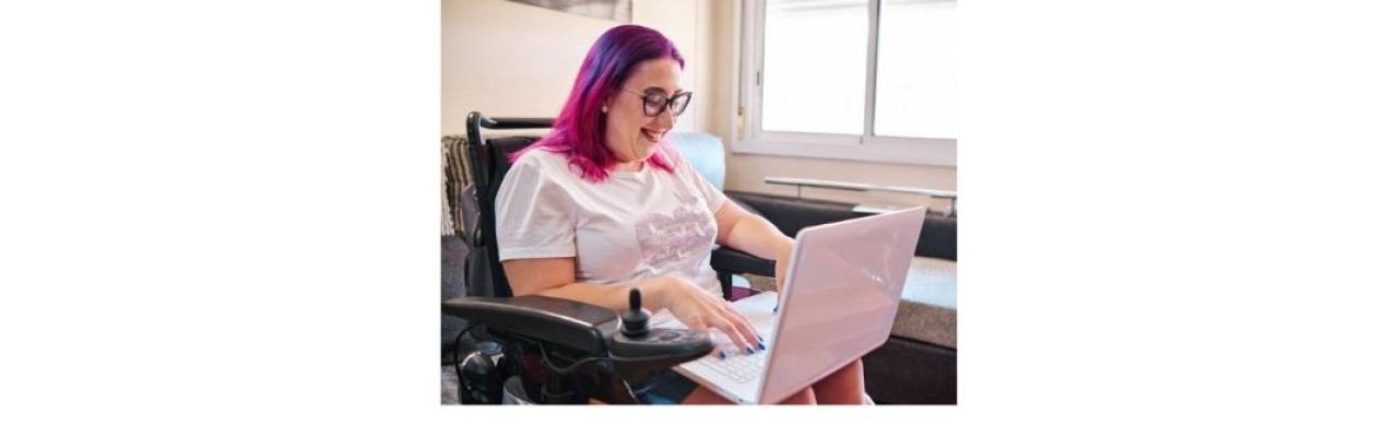 photo of a woman in a wheelchair working