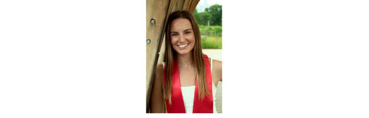 photo of Lorie Cashdollar, a young white woman with straight long brown hair wearing a red graduation sash