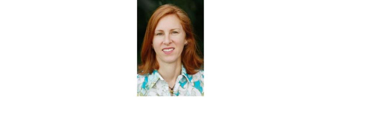 photo of Allison Shapiro, a young white woman with red hair and a flower print shirt