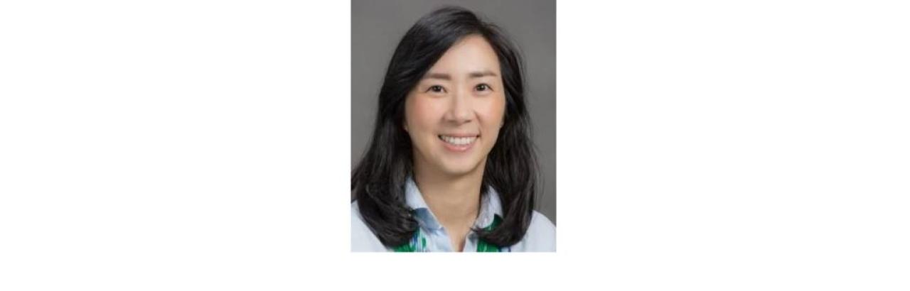 Color photo of Danbi Lee, a young Asian woman with shoulder length black hair wearing a light blue button down shirt