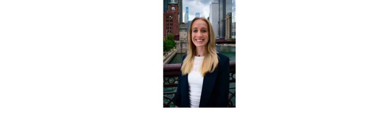 a color photo of Nicole Sharf, a young white woman with shoulder length blonde hair standing on a bridge over the Chicago River with buildings in the background