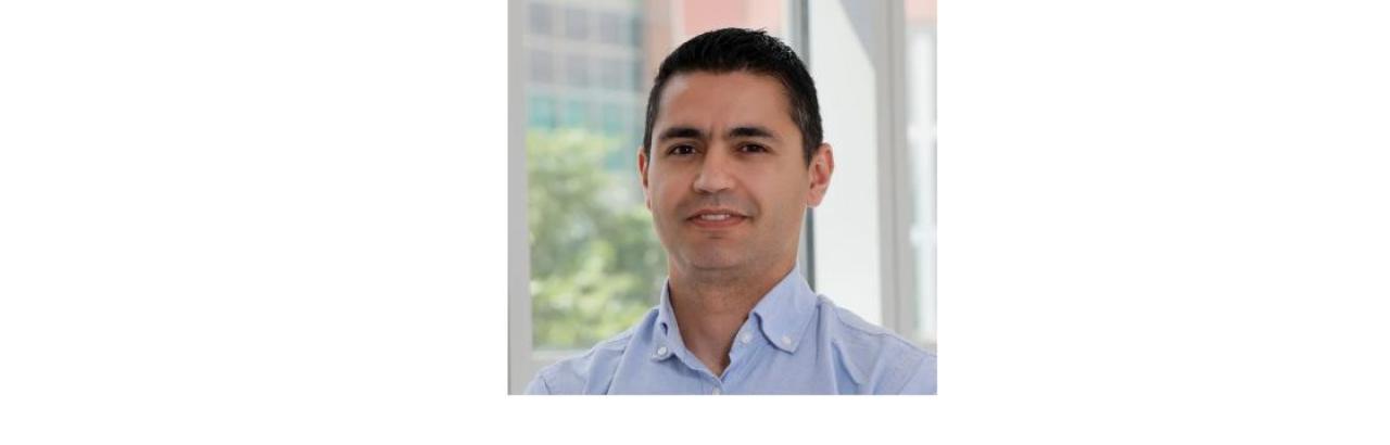 color photo of Tiago Jesus, a young Portuguese man with black hair wearing a button down 
