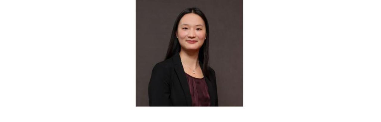 color photo of Amy Zhou, a young woman of Chinese descent with long black hair wearing a black top