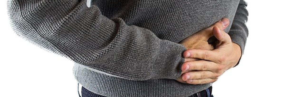 Man holding mid section