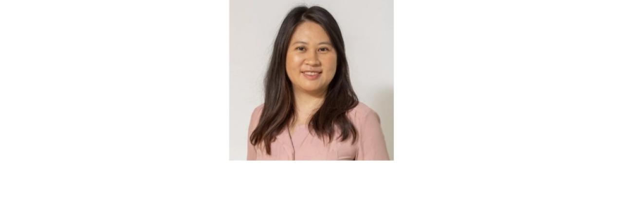 Color photo of Manrui Zhang, a young Chinese American woman with shoulder lengths black hair wearing a pink blouse