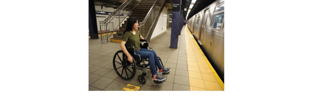 Photo of a woman in a wheelchair at a subway platform
