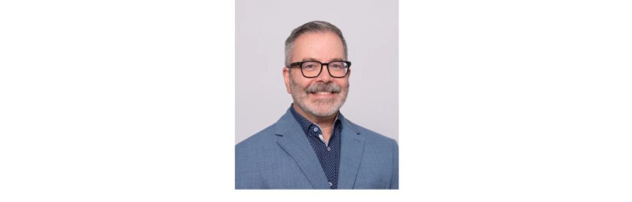 Photo of Roberto López-Rosado, PT, DPT a middle aged man with a black beard and glasses wearing a blue siut