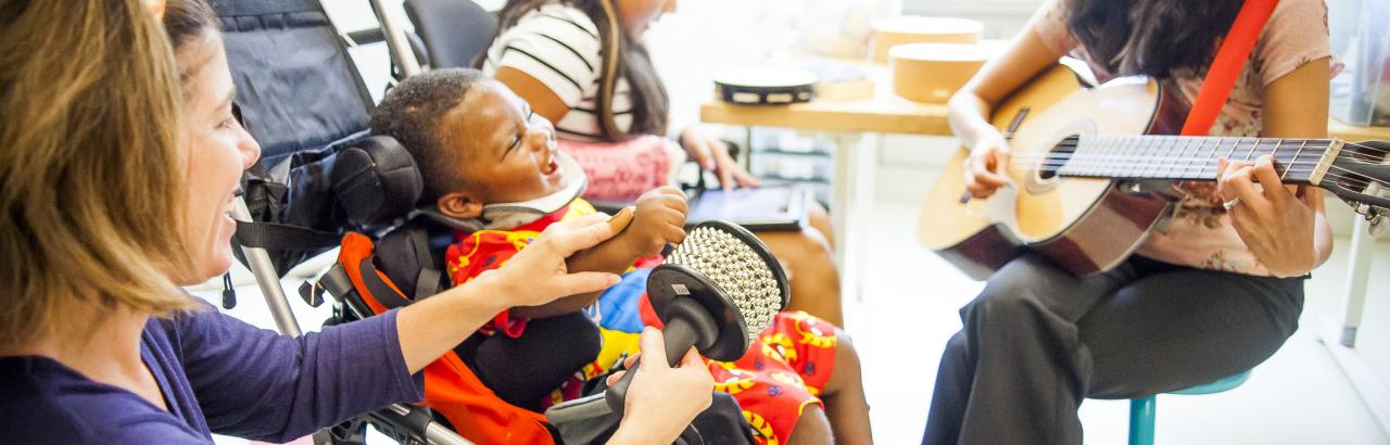 Music therapist works with a pediatric patient