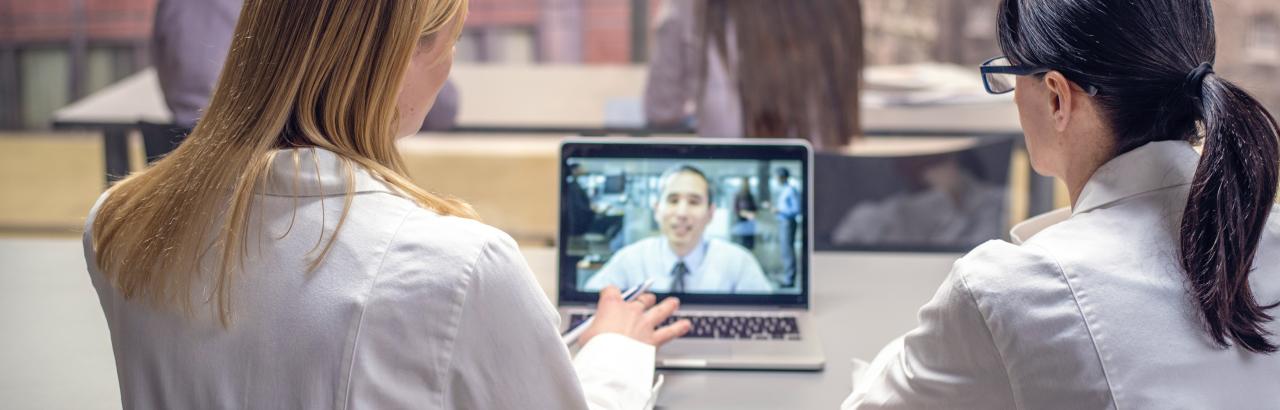 Nurse helps a patient with their Portal Log in