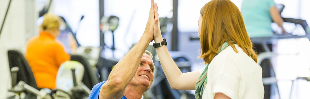 A patient and Shirley Ryan AbilityLab staff member high-five