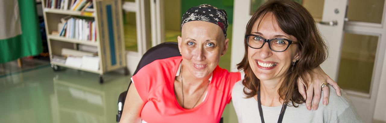 Cancer survivor smiling with her physician