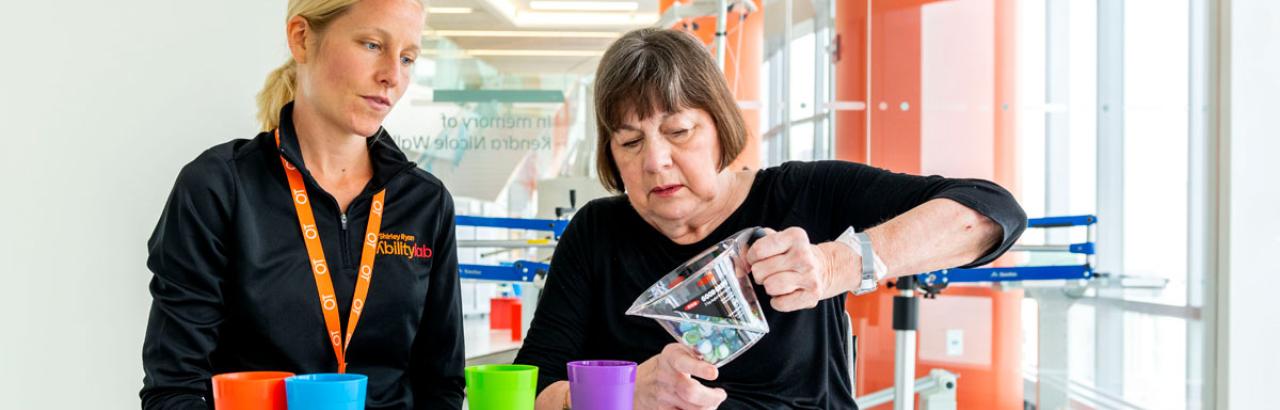 therapist and patient doing fine motor therapy with hands and arms