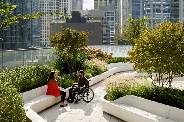 urban garden with couple talking, one in a wheelchair