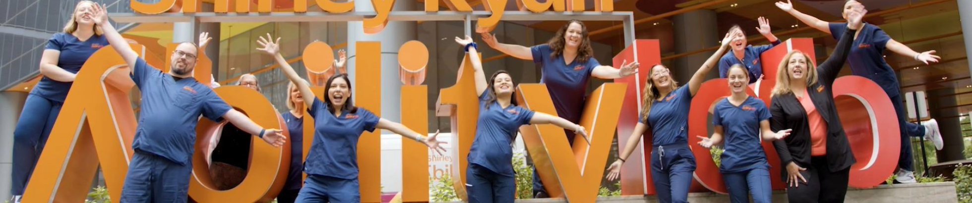 Group of nurses in front of Shirley Ryan AbilityLab sign