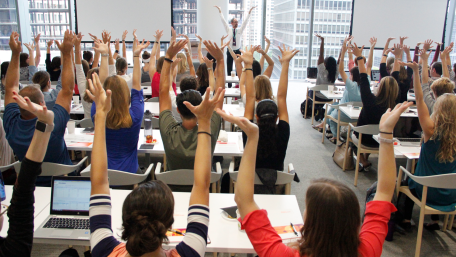 learners at an Academy course raising their hands 