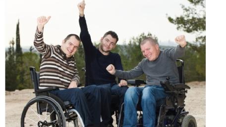 three happy men in wheelchairs