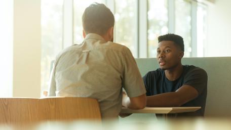 couple of men facing one another