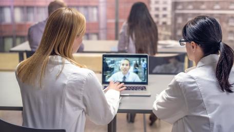 Nurse helps a patient with their Portal Log in