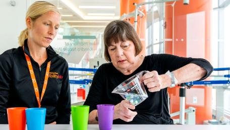 therapist and patient doing fine motor therapy with hands and arms