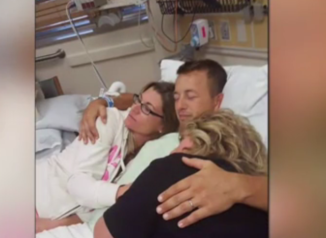 Cole hugs his family while recovering from the SCI