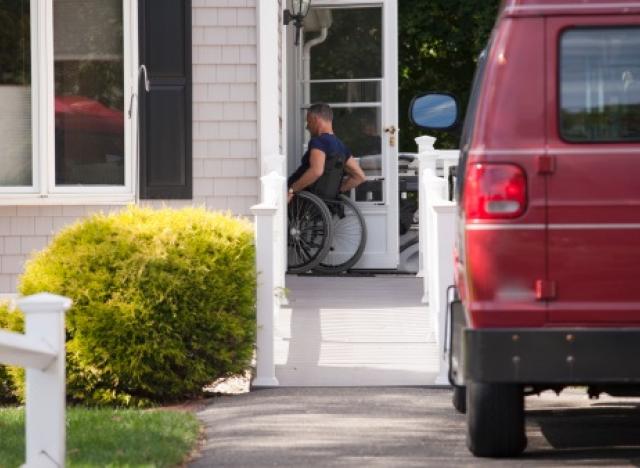 Man going into house