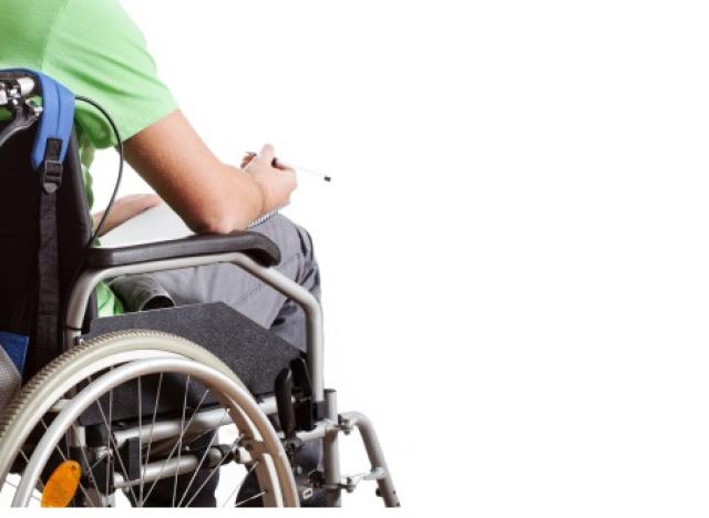 guy with green shirt, backpack in wheelchair