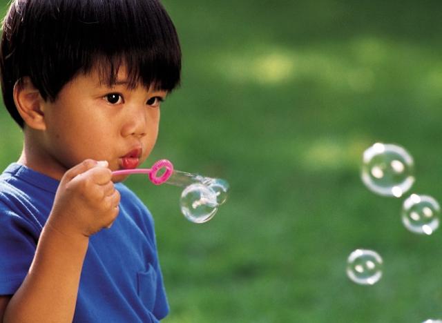 boy blowing bubbles