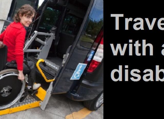 woman being pushed onto van ramp lift