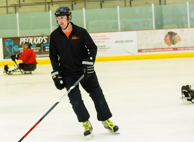derek Daniels playing hockey with the adaptive hockey team