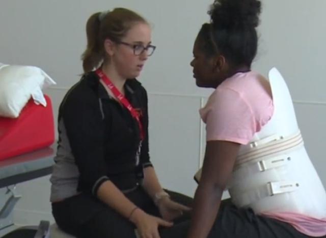 paralyzed patient from Peoria working with her physical therapist