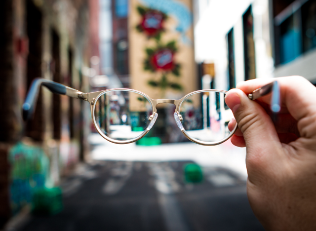 blurry street and glasses in focus