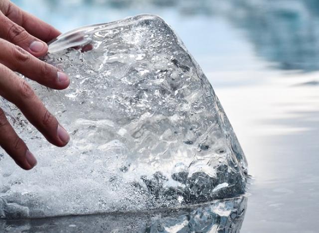 hands on ice chunk