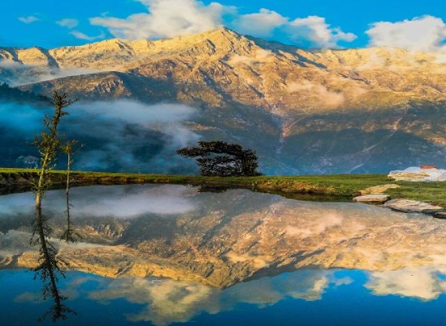 mountains with peach clouds reflected in water