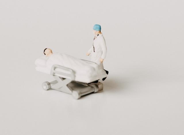 lego toy patient in bed and dr standing next to hospital bed