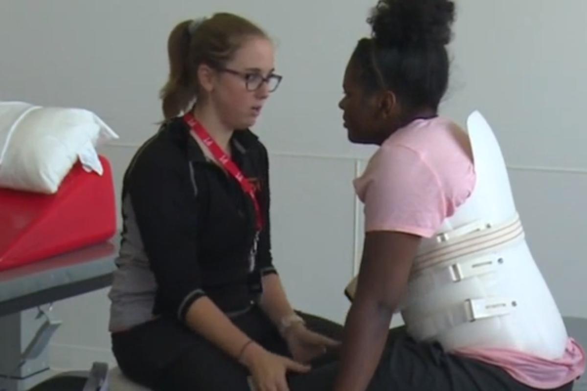 paralyzed patient from Peoria working with her physical therapist