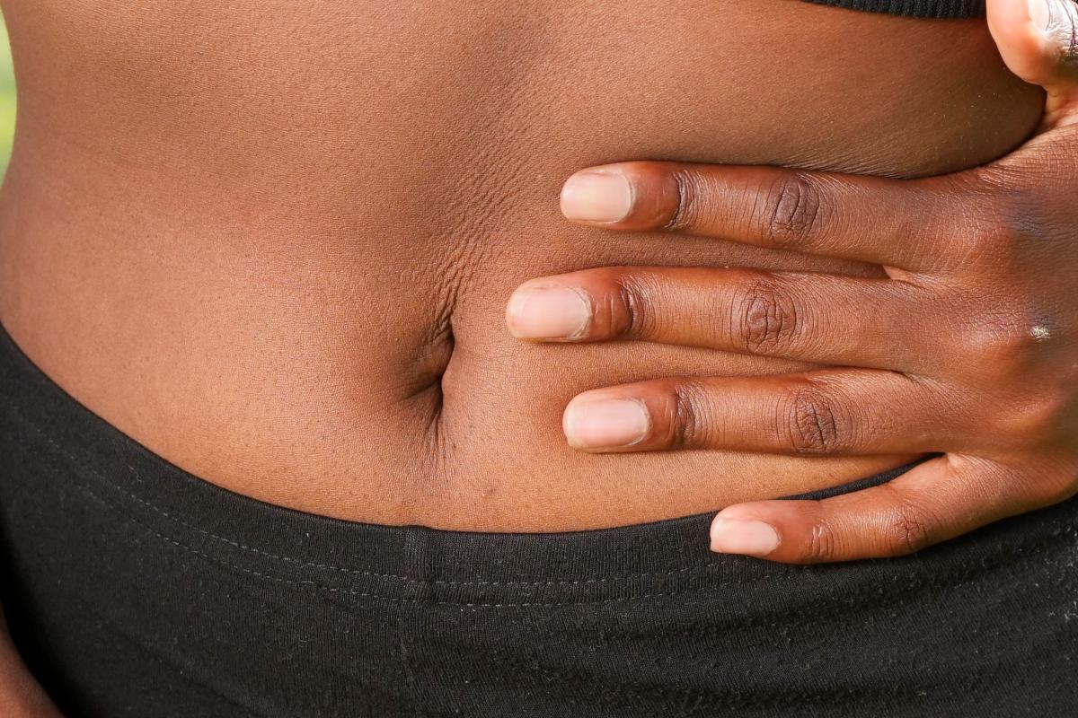 woman stomach gripping