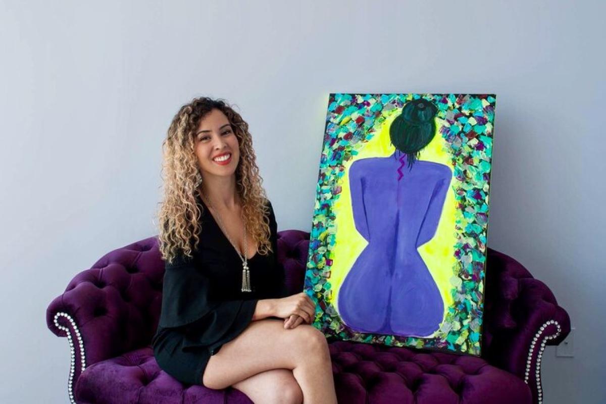 Genevieve in her studio with one of her paintings