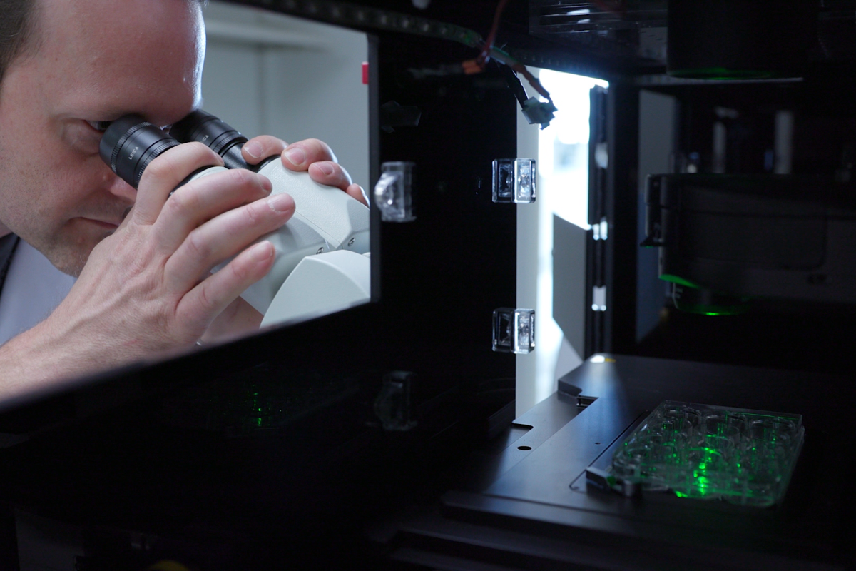 Researcher with microscope