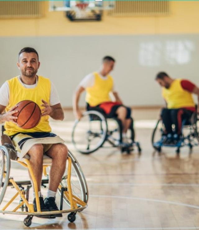 Men playing basketball and using wheelchairs
