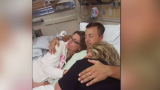 Cole hugs his family while recovering from the SCI