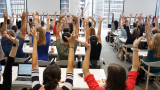 learners at an Academy course raising their hands 