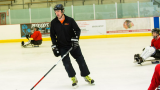 derek Daniels playing hockey with the adaptive hockey team
