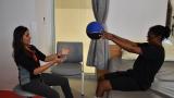 patient holds ball with hands during therapy with physical therapy