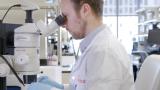 Man in lab coat in biologics lab