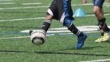 Children playing soccer outdoors
