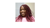 young black woman with pink top and pink braids, smiling