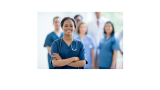 African American nurse with arms crossed and smiling with nurse colleagues in the bacground